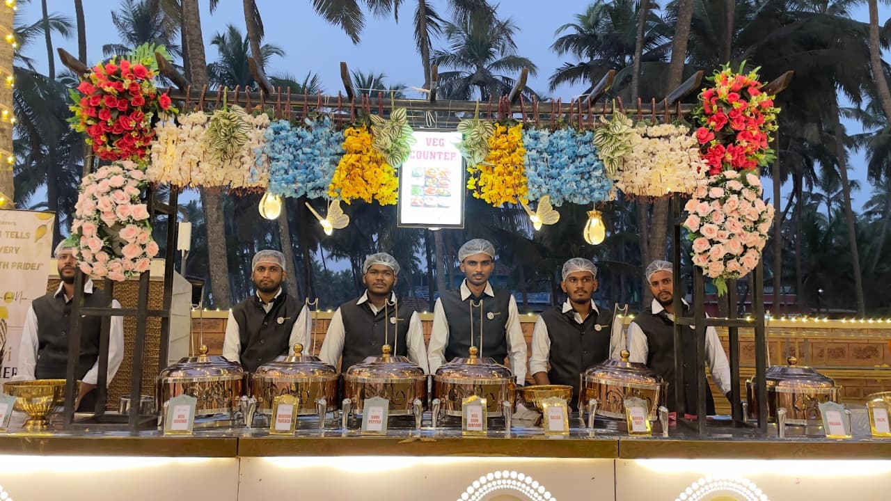 Shanvi Caterers veg counter with golden chafing dishes and floral decor