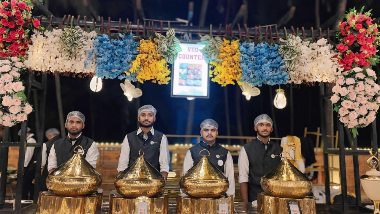 Night closeup of Shanvi Caterers veg counter servers with golden vessels